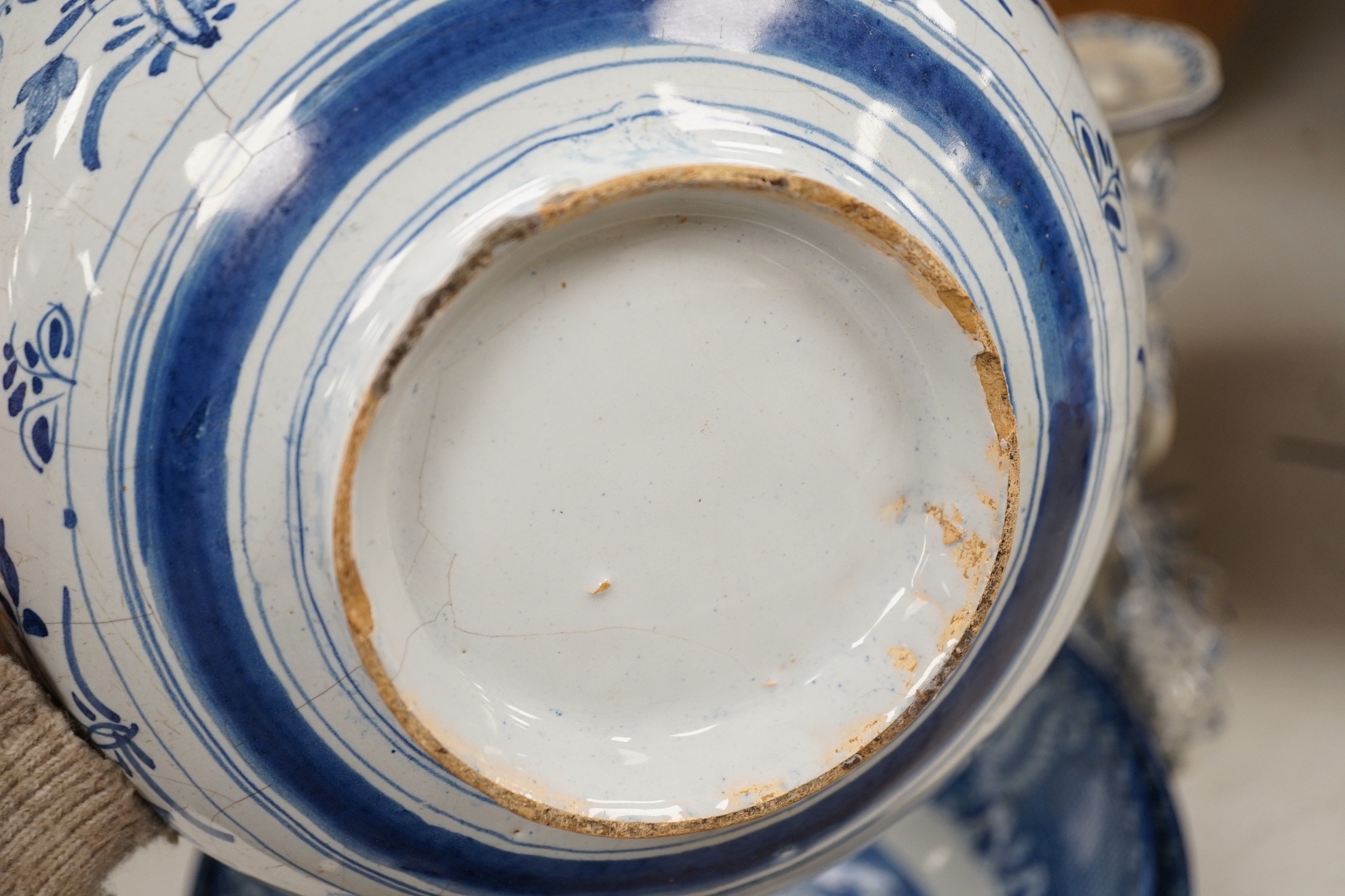 A pair of Delft blue and white candlesticks together with an 18th century Delft bowl, a Moroccan pottery jar with cover, and two pearlware bowls